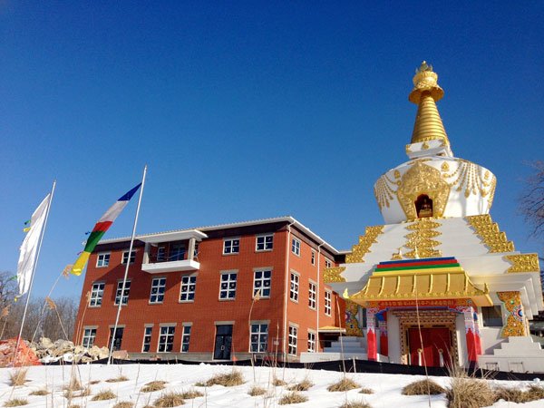 Prayer Flags Blowing Blessings Between Maitreya Center and Stupa.