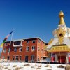 Prayer Flags Blowing Blessings Between Maitreya Center and Stupa.